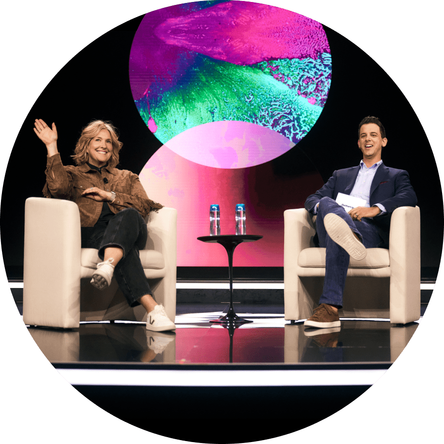 Brenè Brown and Alexi Robichaux on a stage together smiling