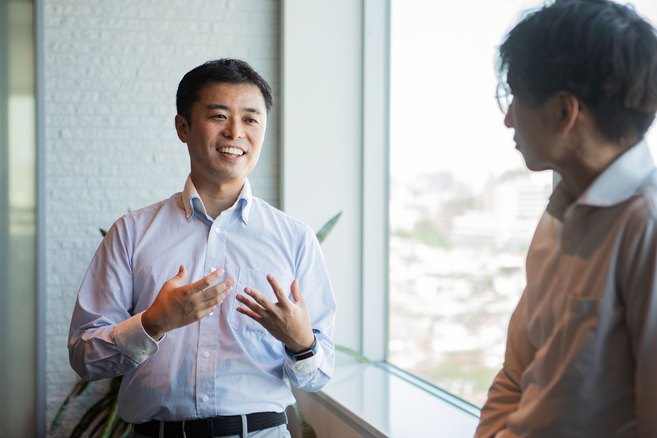 A-man-talking-to-a-colleague-during-a-break-reentering-the-workforce