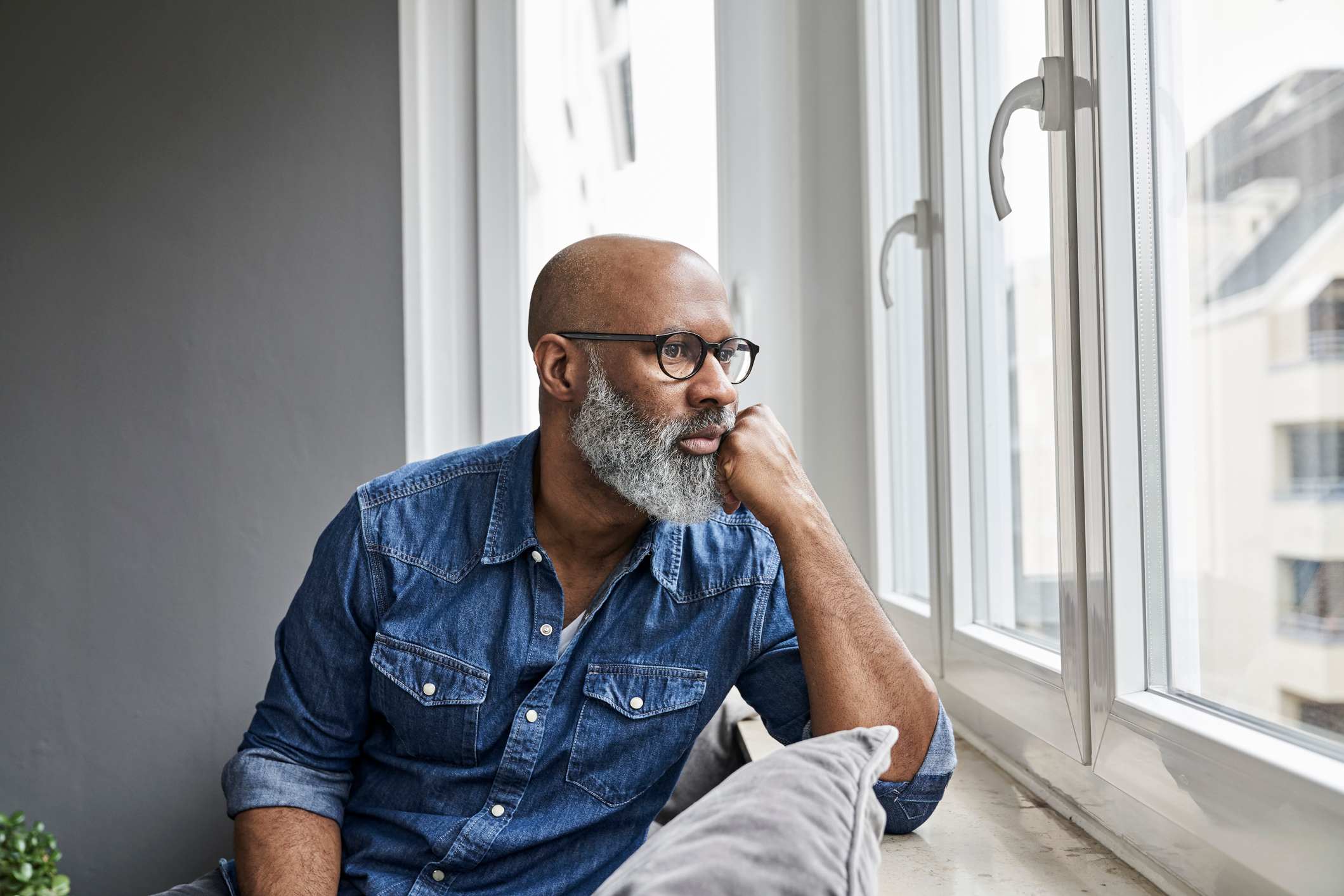 Anxious-man-looking-out-the-window-alone-i-feel-like-i-dont-belong