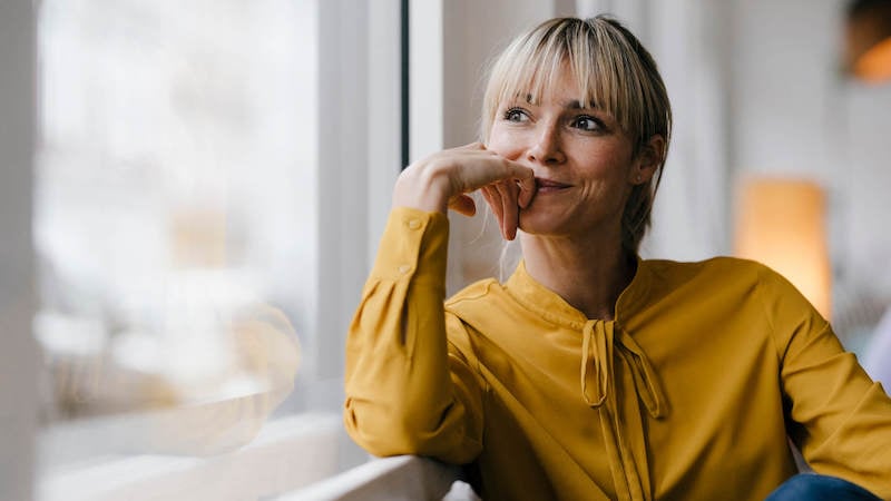 big-picture-thinking-woman-with-arm-at-window-thinking