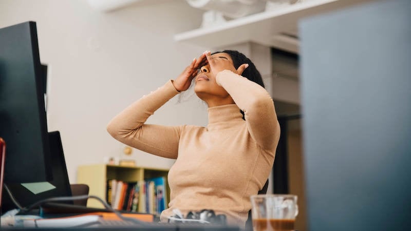 fatigue-management-in-the-workplace-woman-at-desk-frustrated
