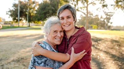 financial-wellness-two-people-smiling-hugging