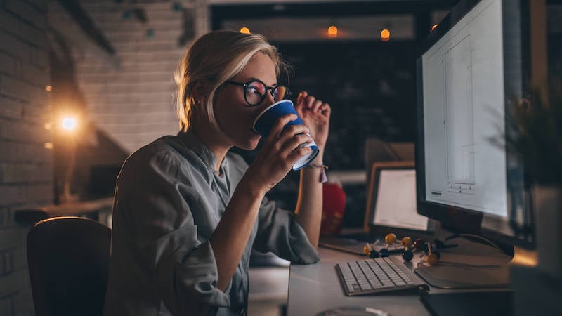 hustle-culture-woman-sipping-coffee-late-at-work