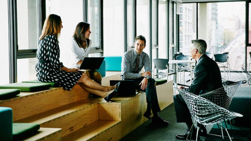 knowledge-management-team-sitting-around-in-break-room