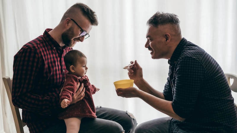 lgbtq-health-disparities-gay-couple-feeding-baby