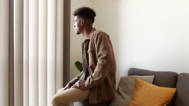mens-mental-health-sitting-on-couch-window