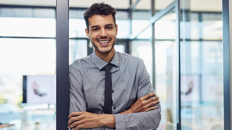 new-manager-training-man-standing-in-conference-room-smiling