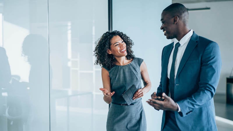 performance-review-questions-two-colleagues-walking-in-office