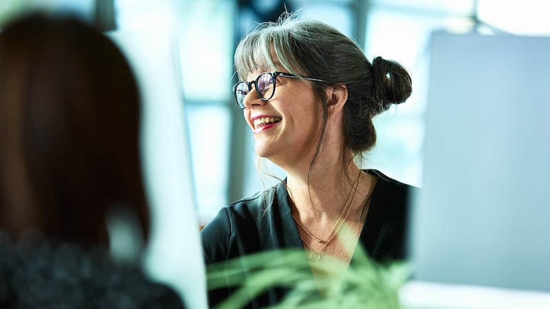 professionalism-in-the-workplace-woman-smiling-in-meeting