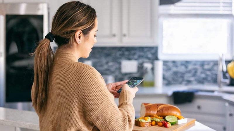 social-media-and-mental-health-girl-on-phone-taking-photo