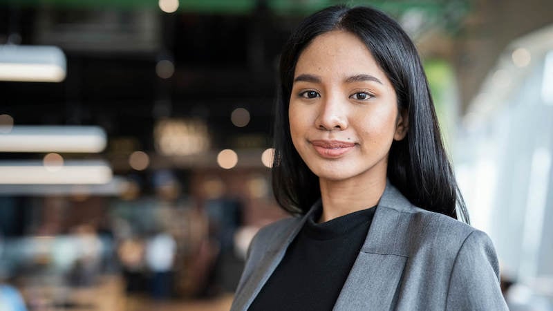 strategic-plan-vs-work-plan-woman-smiling-at-camera