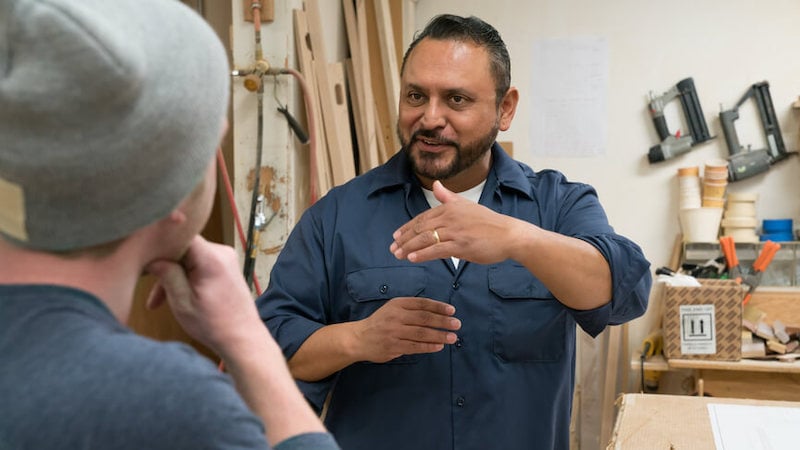 transformational-leadership-two-workers-talking-in-shed