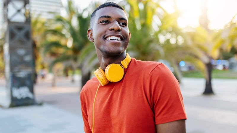 what-to-do-on-a-mental-health-day-man-smiling-with-headphones