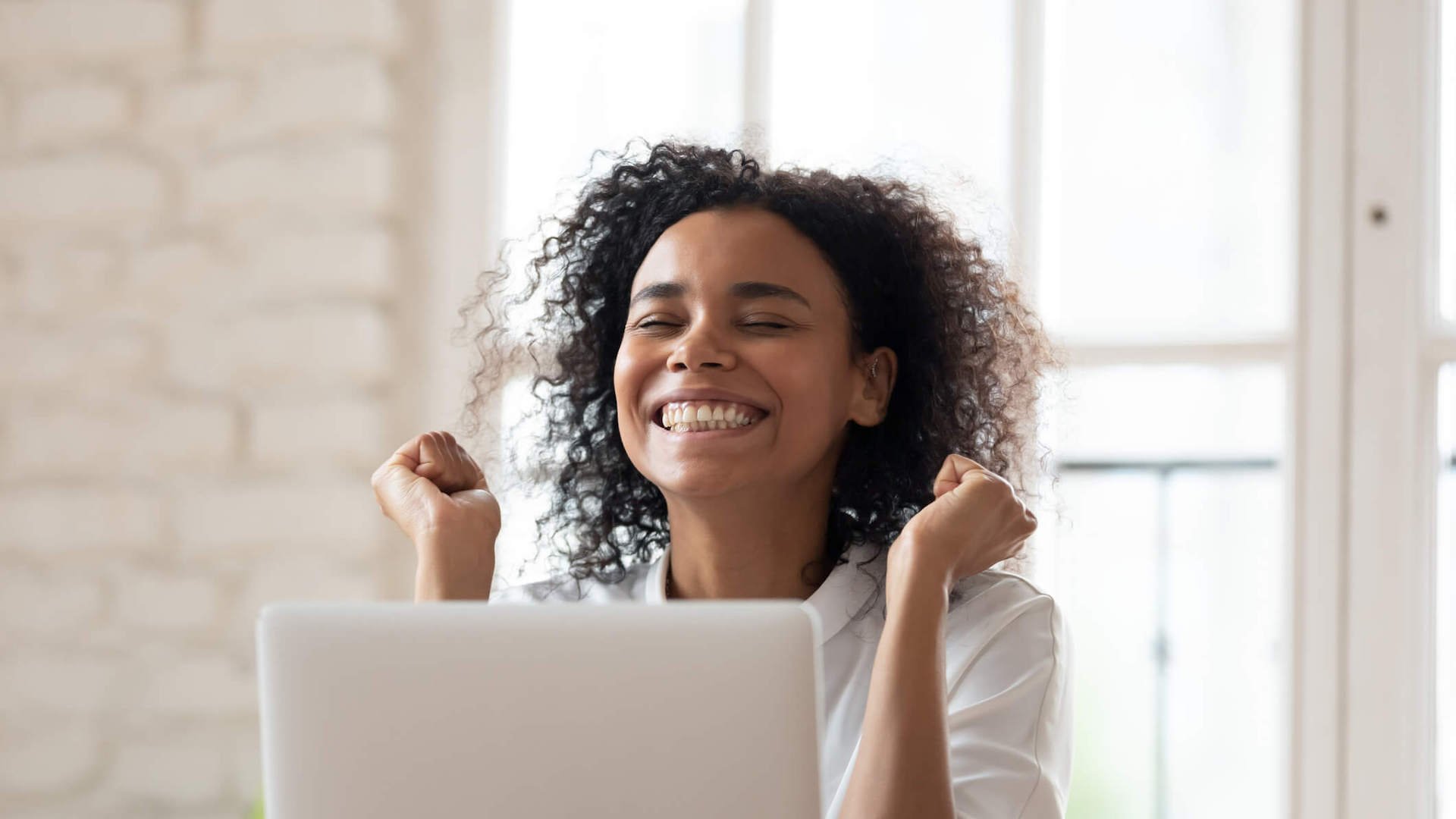 asking-for-a-salary-range-person-celebrating-in-front-of-laptop