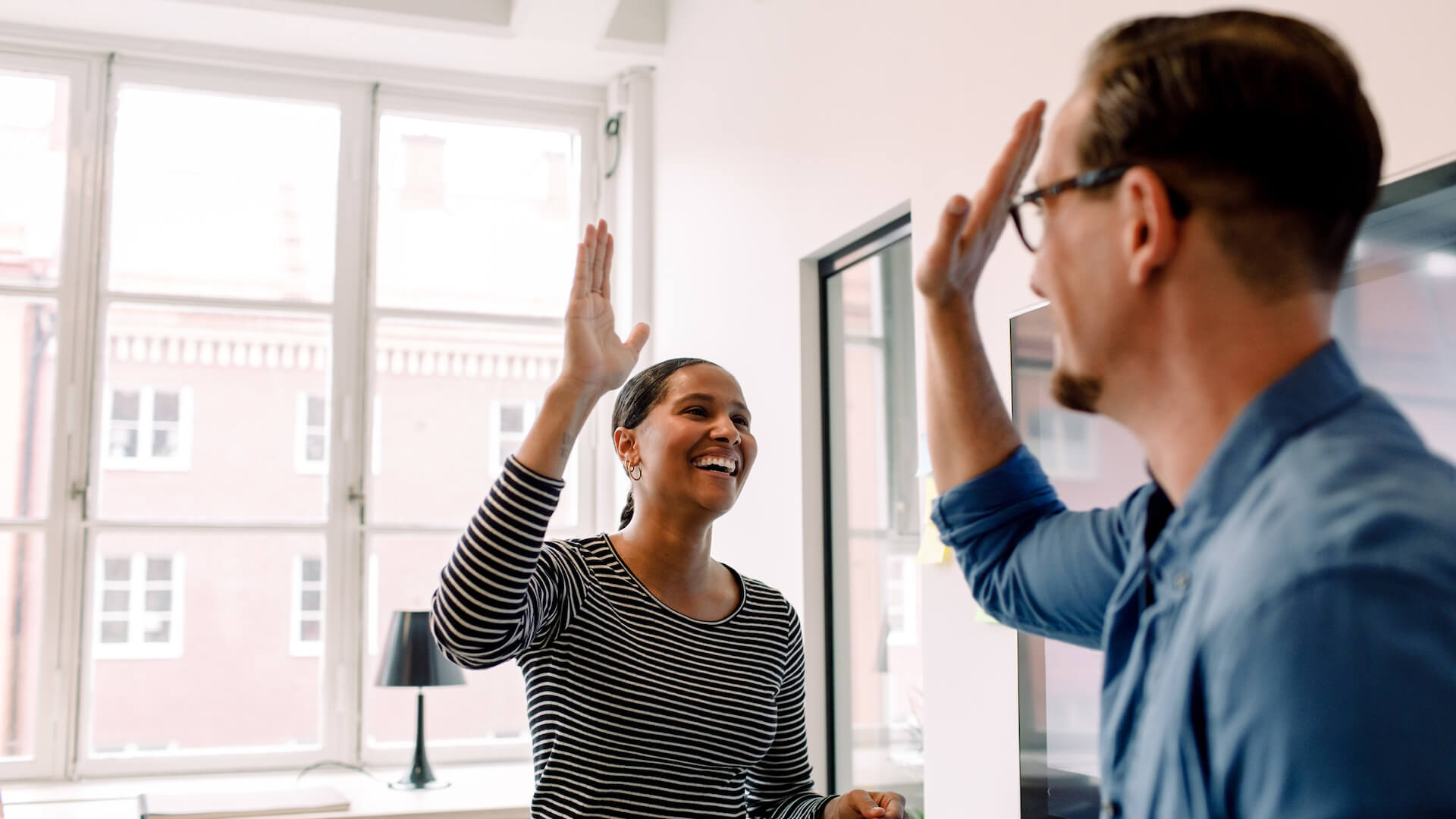 coaching-leadership-style-examples-two-people-high-fiving