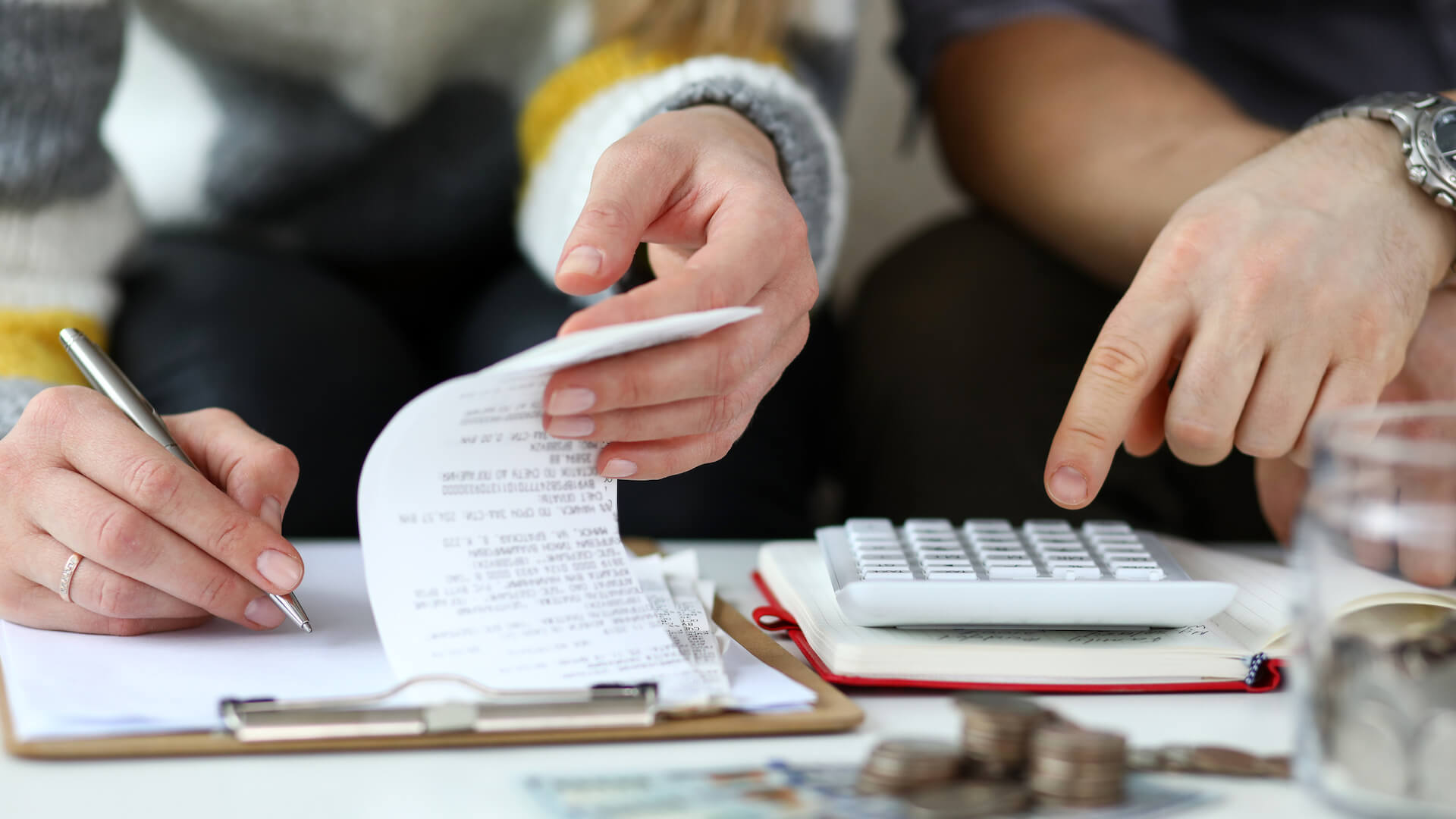 debt-and-mental-health-close-up-of-hands-going-through-financial-paperwork