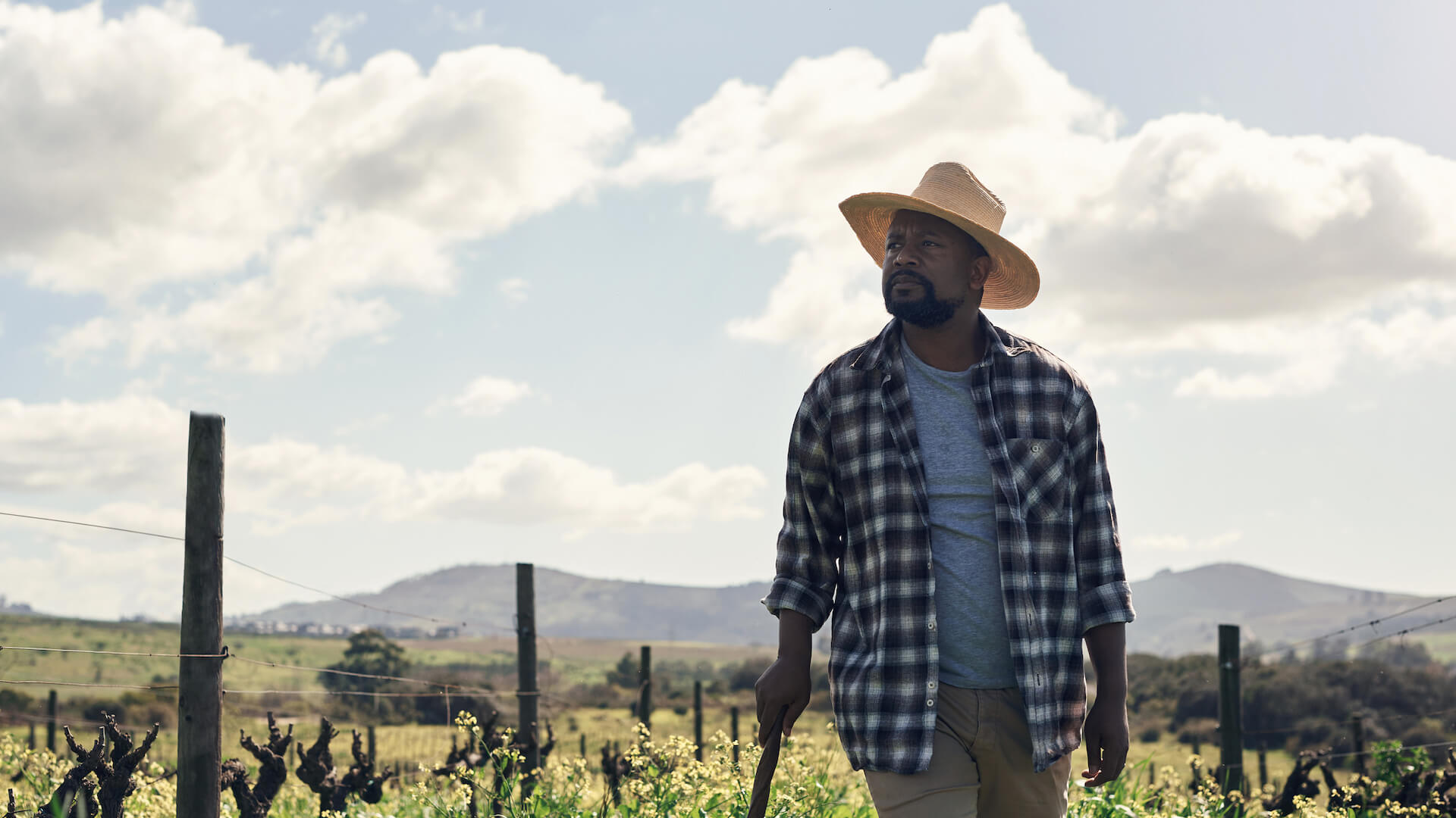 eco-anxiety-a-farmer-looking-into-distance-in-field