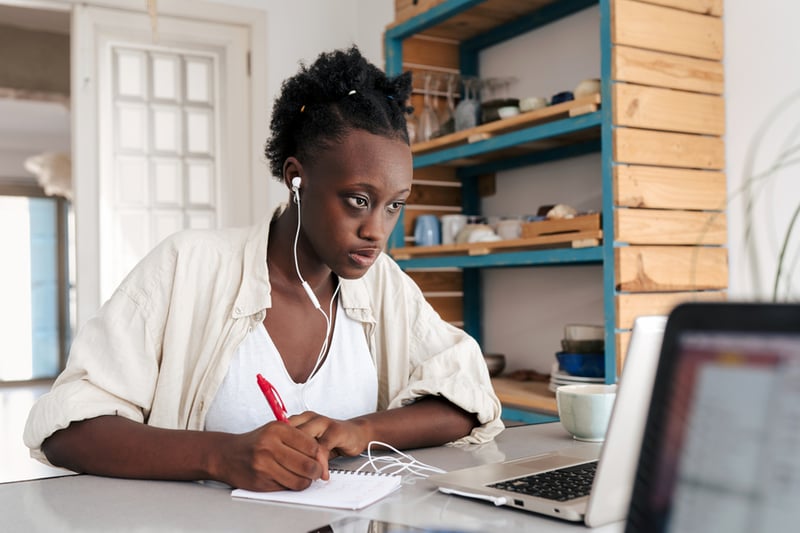 woman-focusing-on-laptop-while-taking-notes-ego-driven