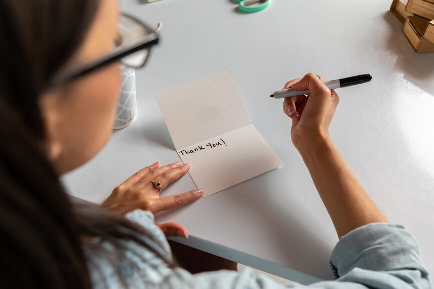 woman-writing-thank-you-card-employee-appreciation-ideas