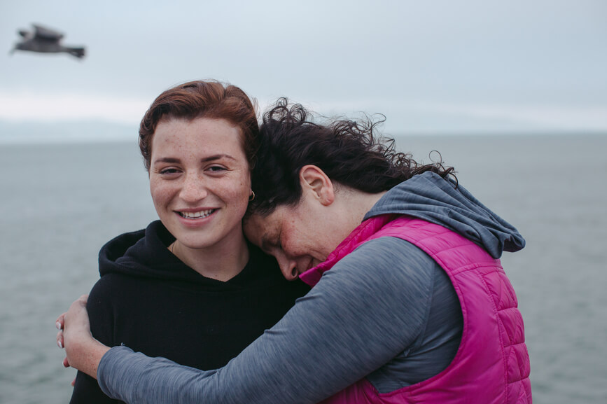 mother-hugging-daughter-on-the-beach-empty-nest-syndrome