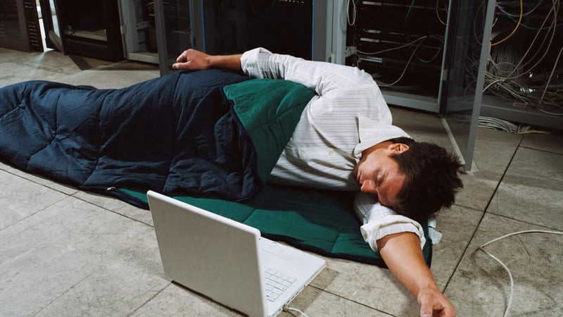 person-lying-on-office-floor-presenteeism