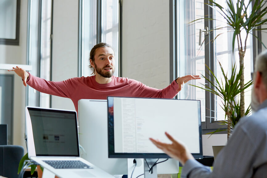 two-male-colleagues-talking-in-office-reverse-mentoring