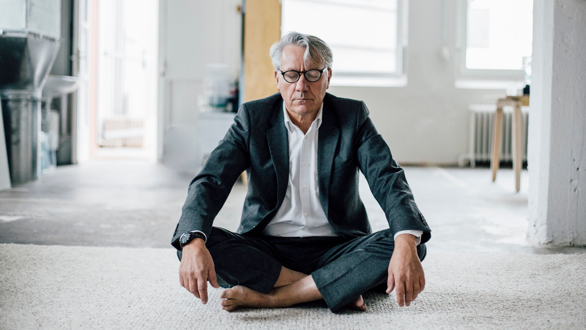 person-meditating-in-office-wellness-initiatives-for-the-workplace