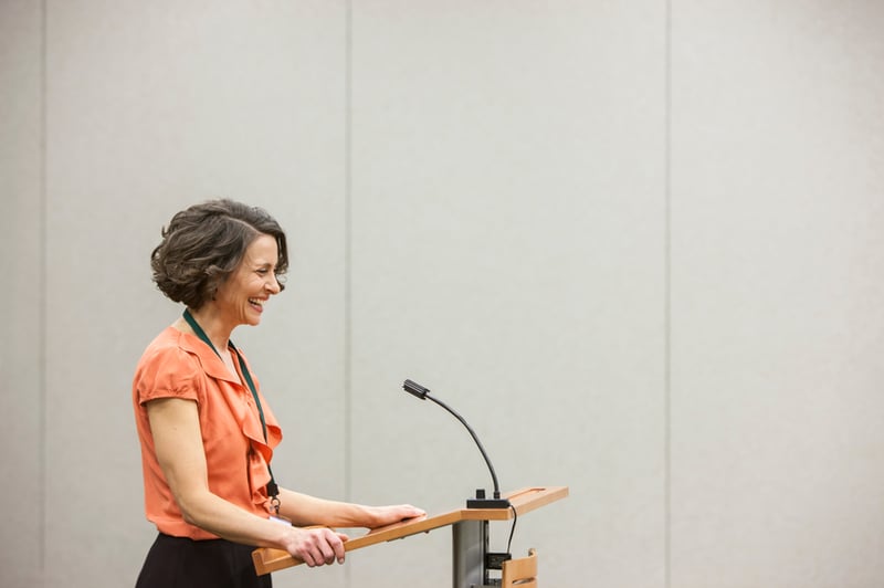 woman-standing-at-podium-smiling-find-your-true-north