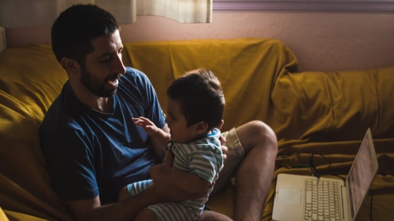 working-parents-dad-with-baby-on-laptop