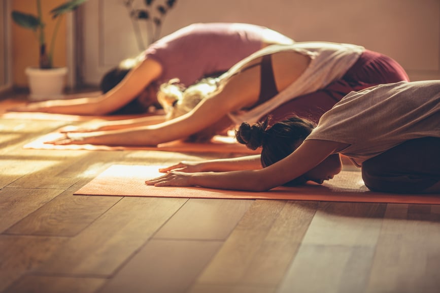three-people-doing-yoga-workplace-wellness