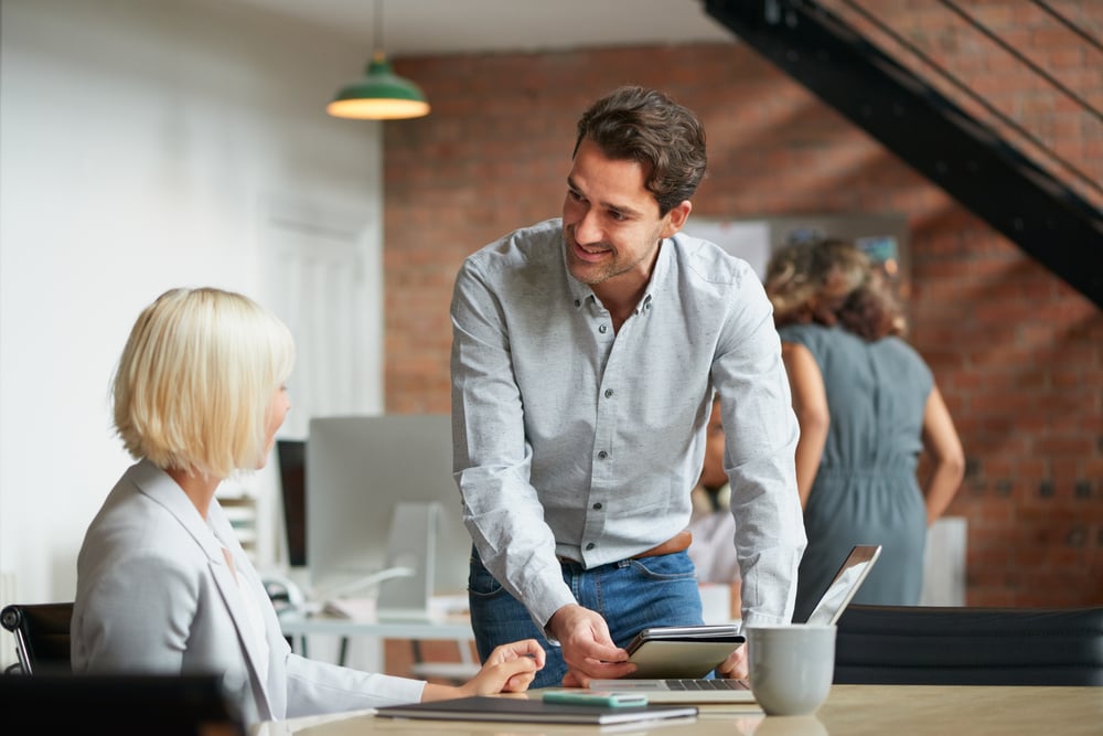 Business-manager-discussing-work-with-colleague-how-to-praise-someone-professionally