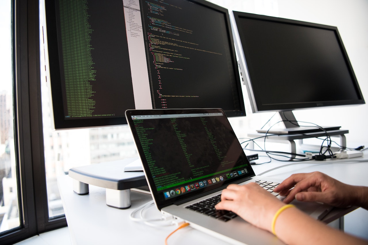 Close-up-Photo-of-Person-typing-codes-on-different-monitors-at-home-office-best-jobs-for-career-change