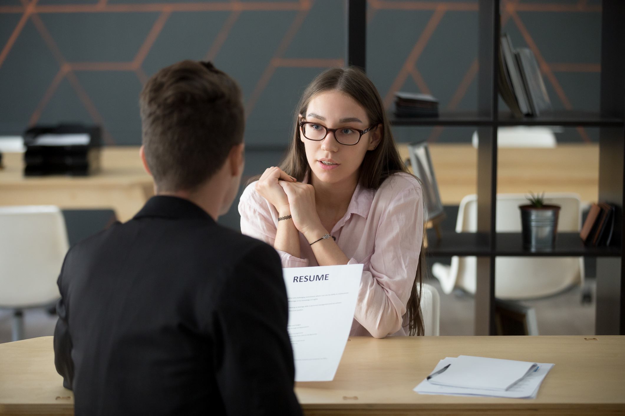 Confident-millennial-female-applicant-talking-at-job-interview-best-job-posting-sites-for-employers-3