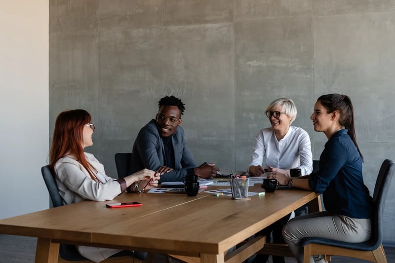 Excited-Modern-Business-People-Listening-Ideas-Of-Colleague