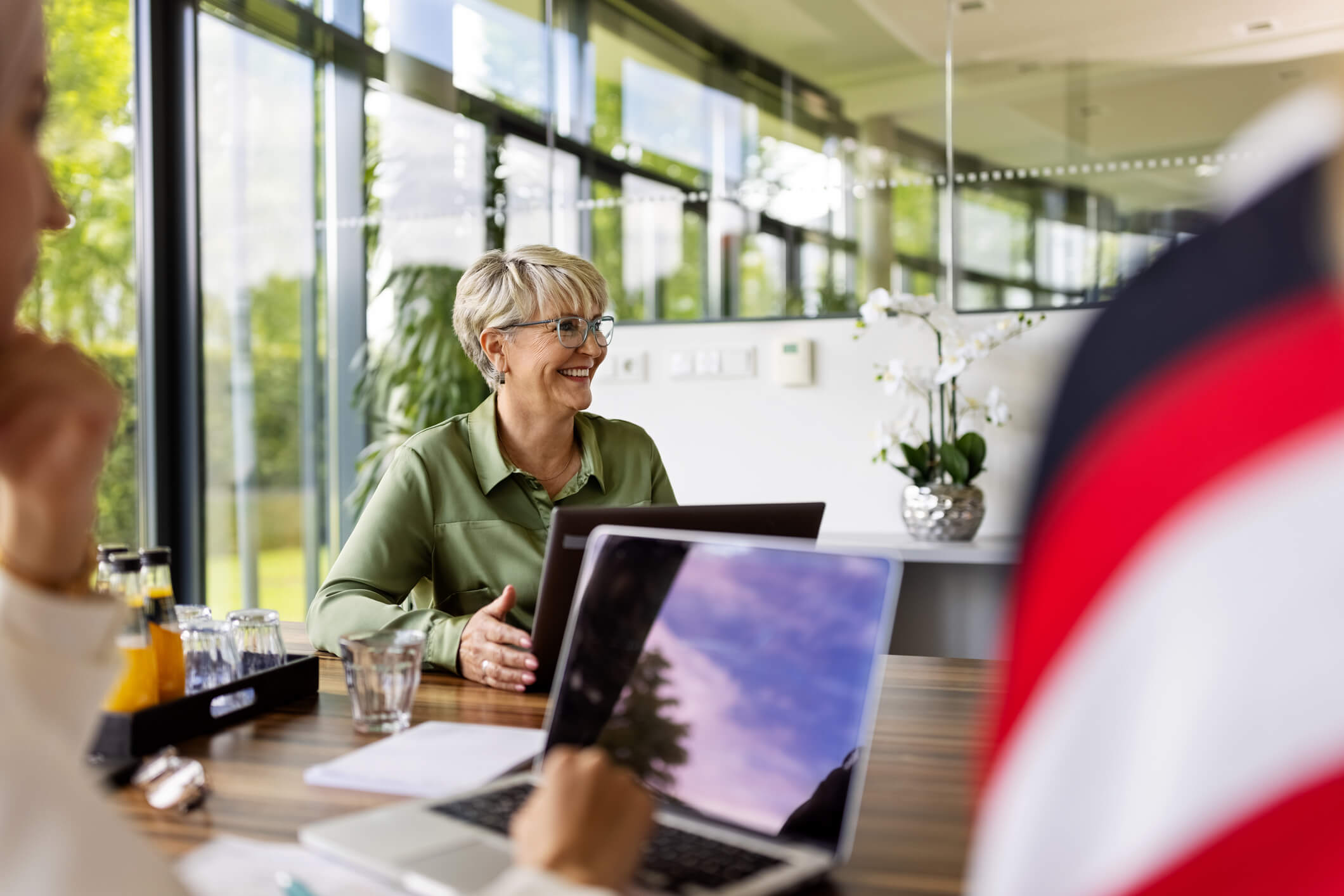 woman smiling at desk overcoming imposter syndrome