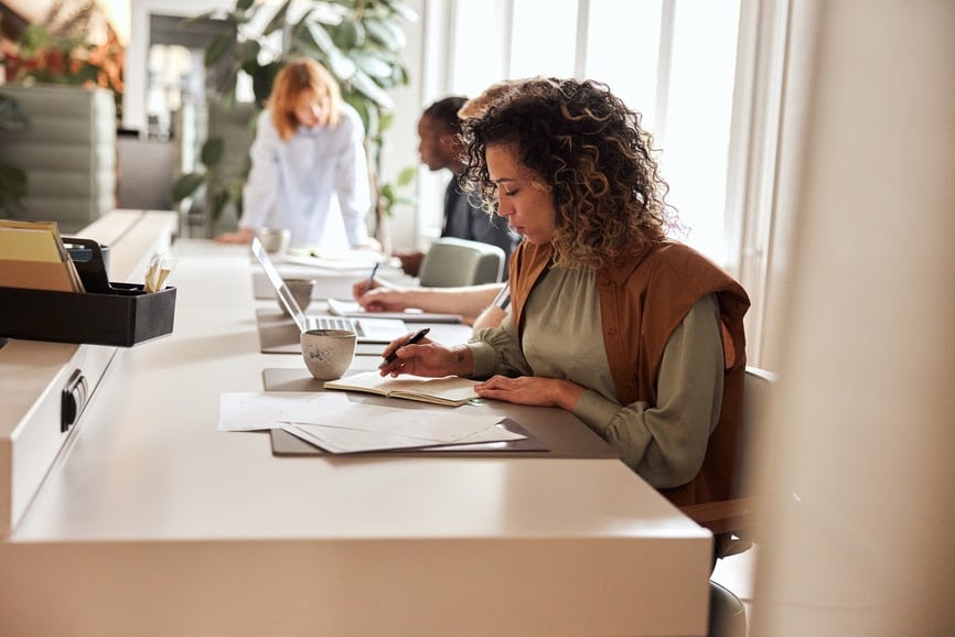 businessowoman-going-over-paperwork-in-an-office-human-resource-reporting