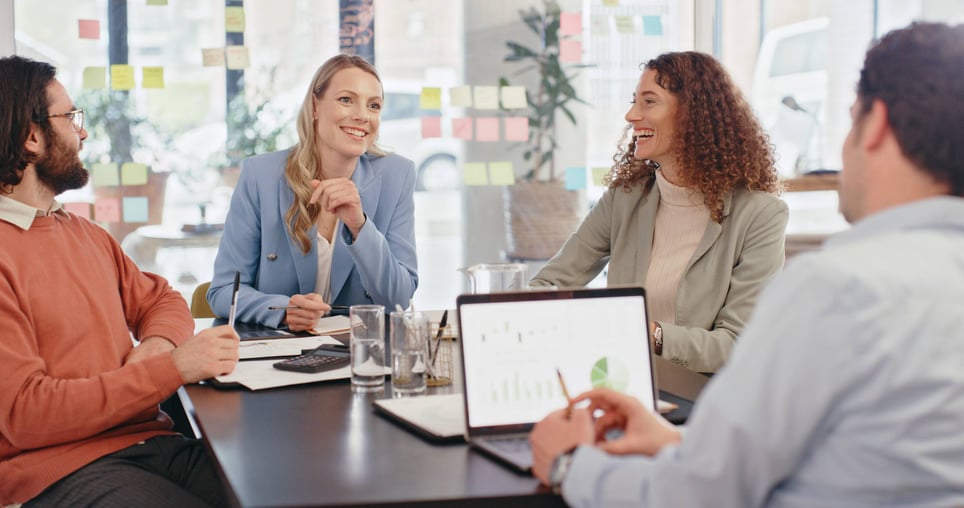 Happy-work-team-collaborating-in-meeting-breaking-down-silos