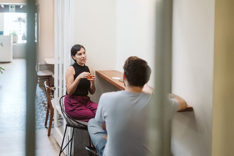 Man and-woman-having-a-conversation-in-a-cafe-1