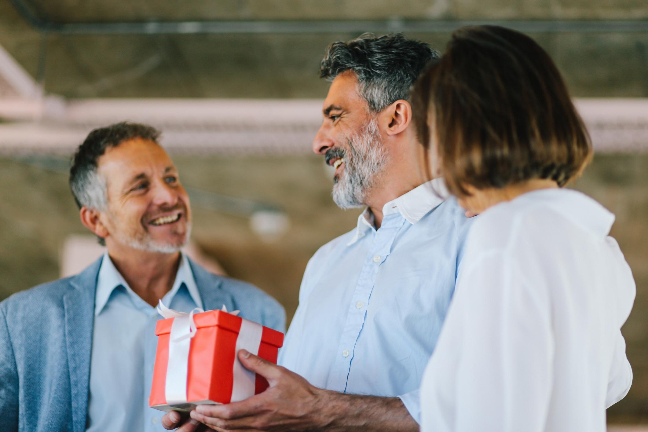 Man-receiving-gift-from-coworkers-love-languages-at-work