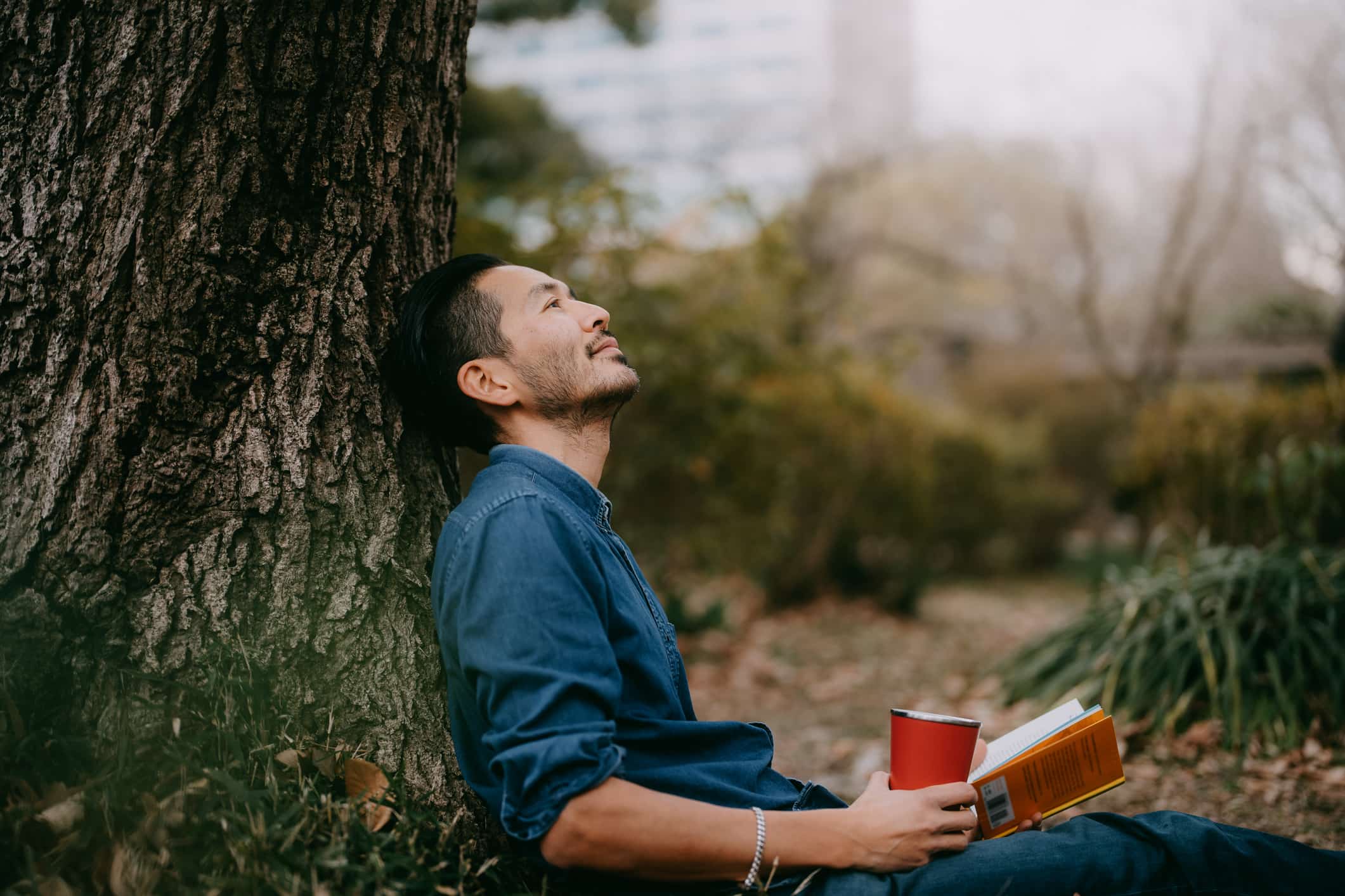 Man-with-book-takes-a-coffee-break-toxic-productivity