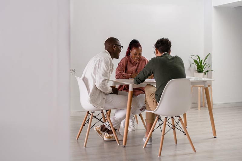 Multiracial-Colleagues-Sitting-At-Table-In-Office-type-A-personality