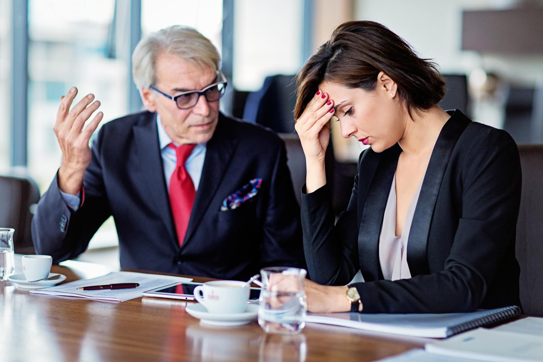 Older-colleague-making-younger-woman-feel-uncomfortable-bullying-at-work