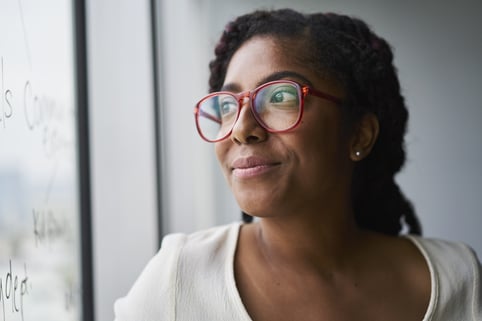 Portrait-of-cheerful-business-woman-looking-out-window -the-importance-of-knowing-yourself