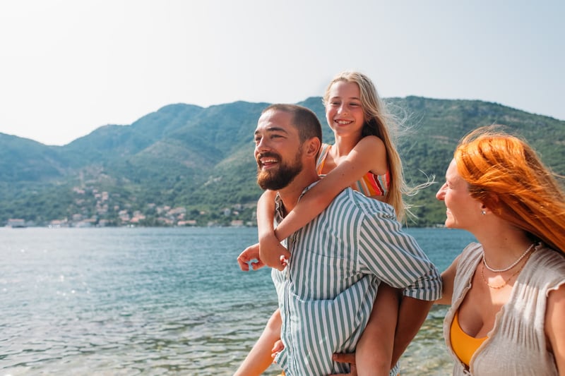 Redhead-woman-her-husband-and-little-daughter-enjoying-on-their-vacation-walking-by-sea-working-too-much