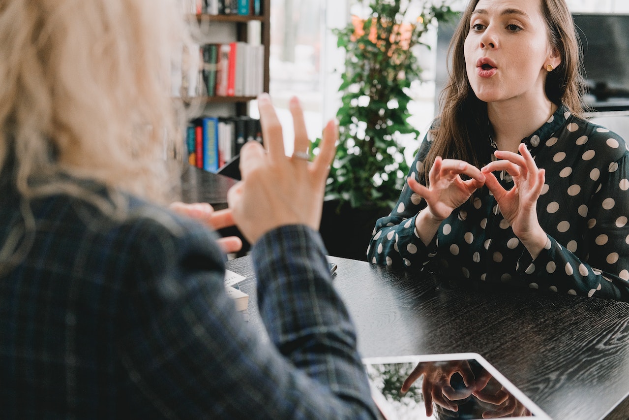 Sign-language-interpreter-talking-to-another-woman-resume-dos-and-donts