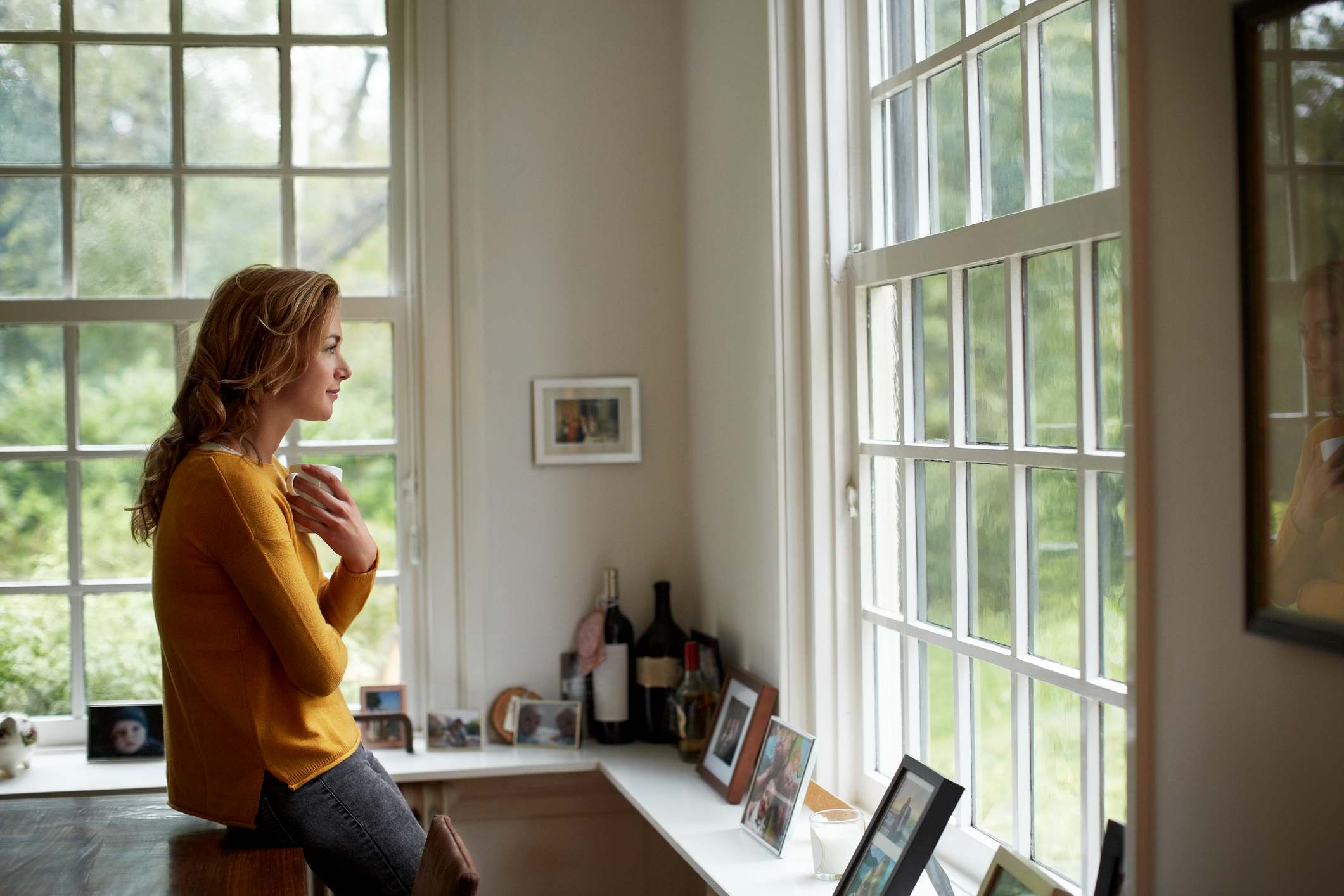 Thoughtful-woman-having-coffee-in-cottage-mom-going-back-to-work-after-10-years