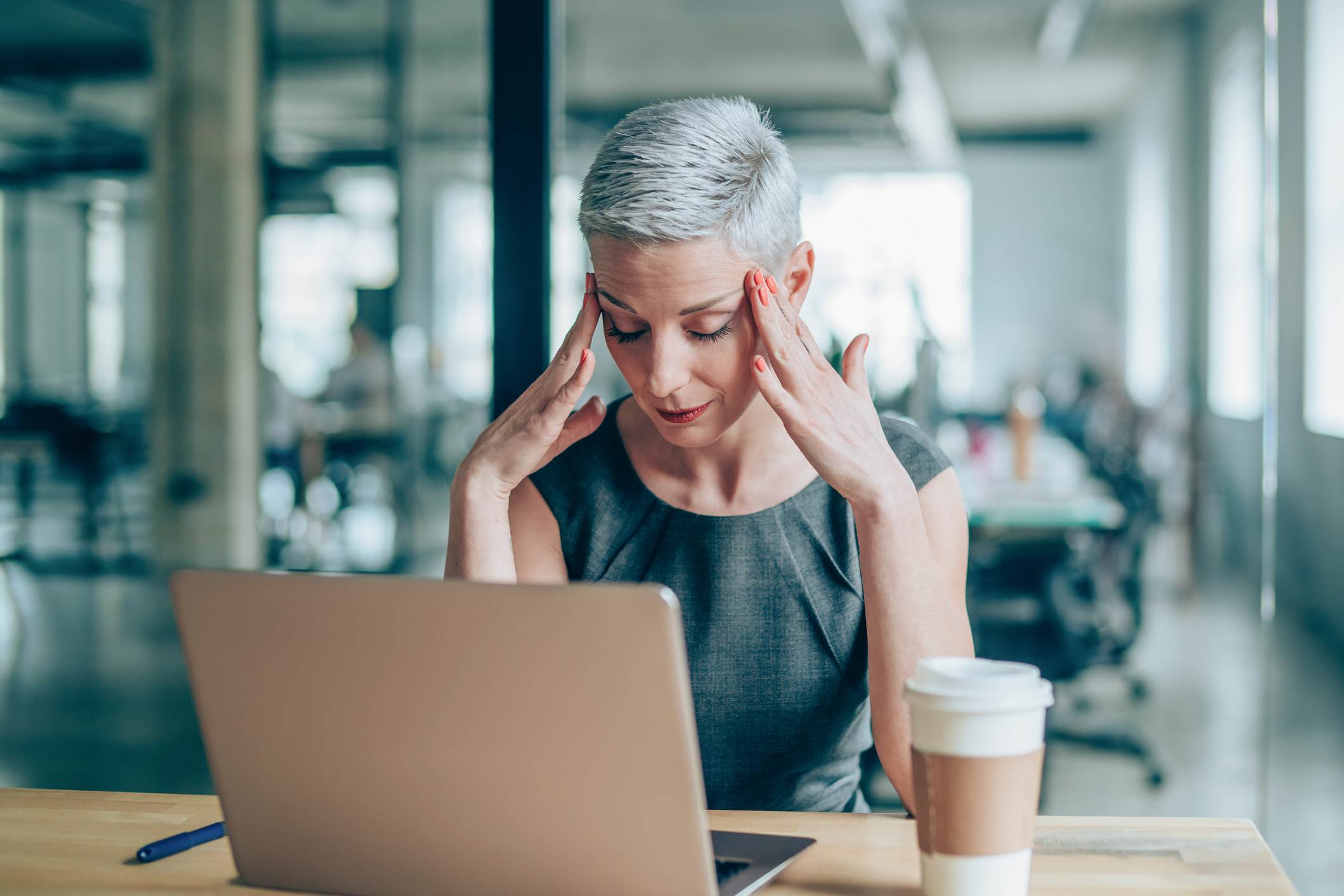 Woman-at-work-holding-her-face-looking-stressed-bad-day-at-work