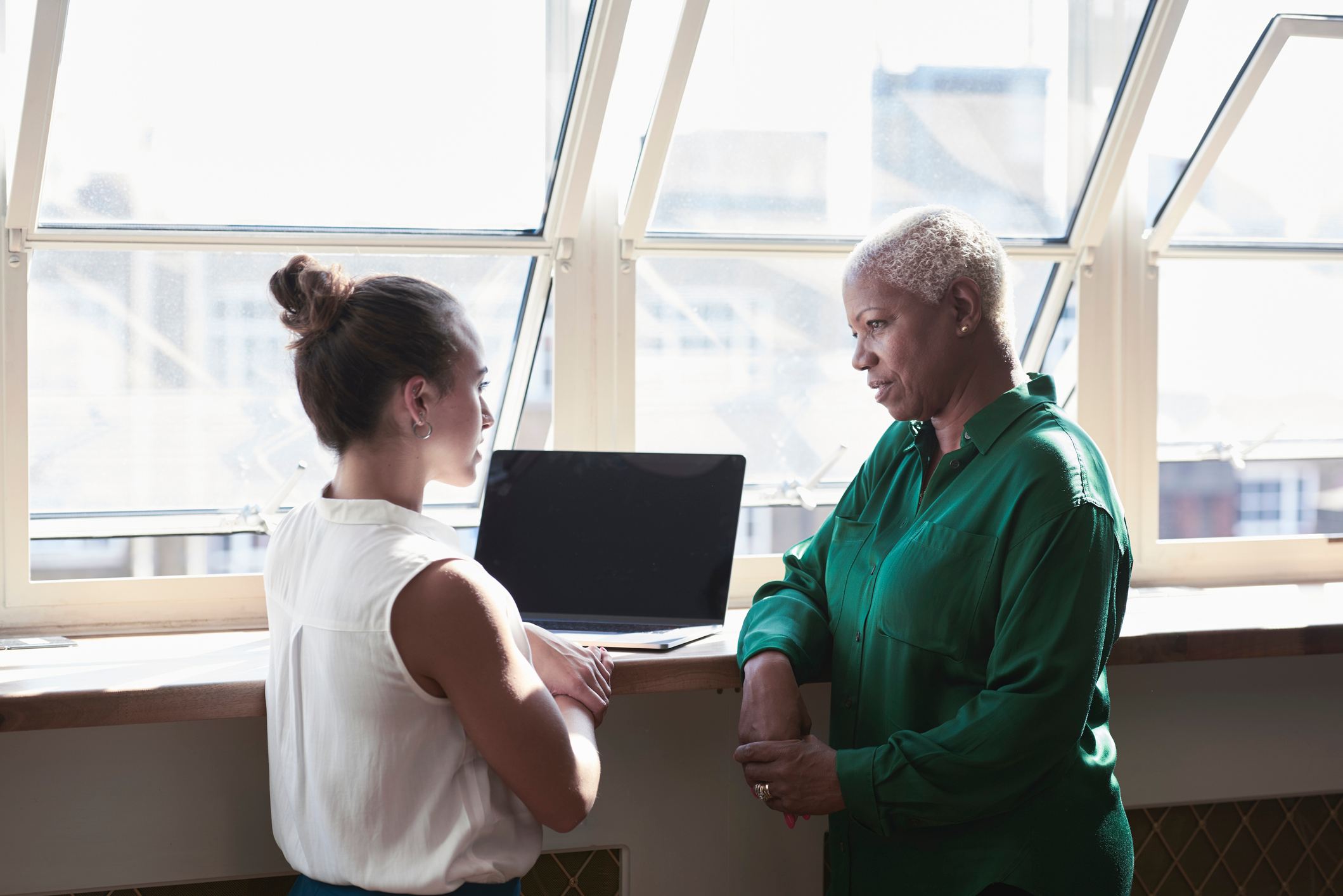 Woman-talking-to-her-manager-at-office-worried-about-getting-fired