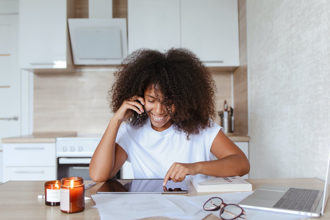 a-woman-in-a-phone-call-while-using-her-digital-tablet