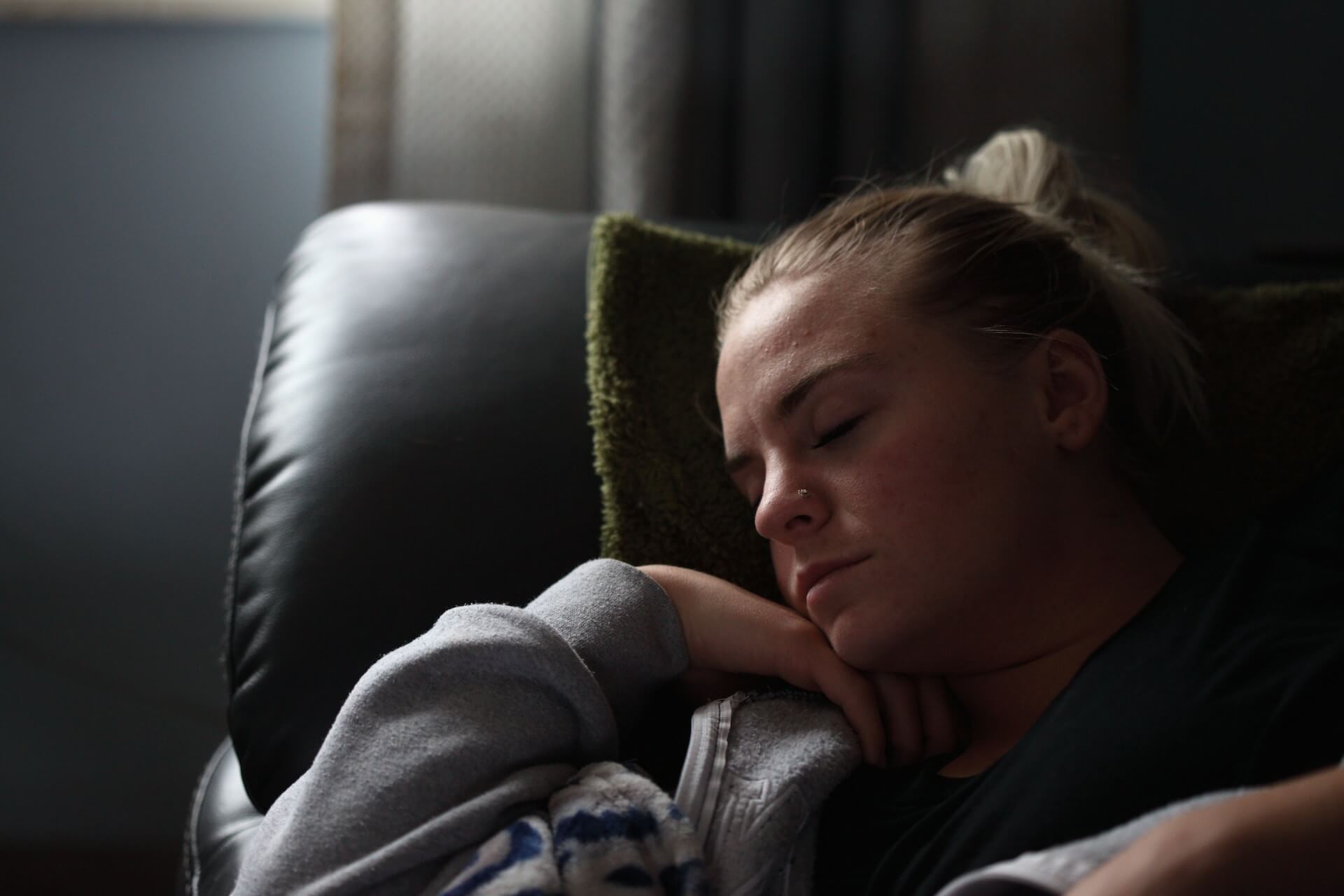 blonde woman napping on chair dreaming